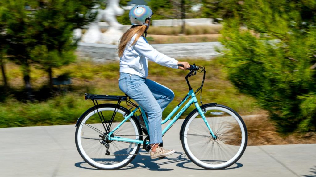 Woman riding an EB9 Step-Through electric bike.