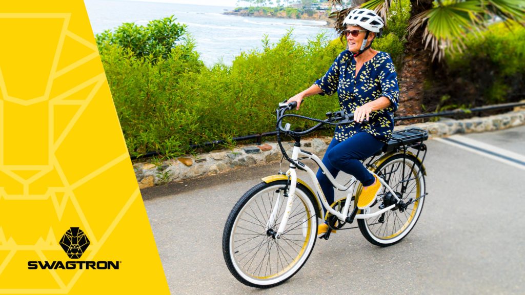 Older woman wearing a helmet, riding an EB10 Step-Through Cruiser eBike.