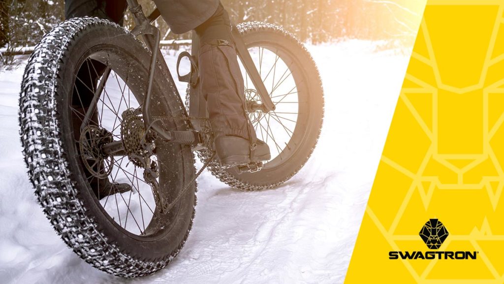 Close-up rear shot of someone riding the EB6 fat-tire eBike in the snow.