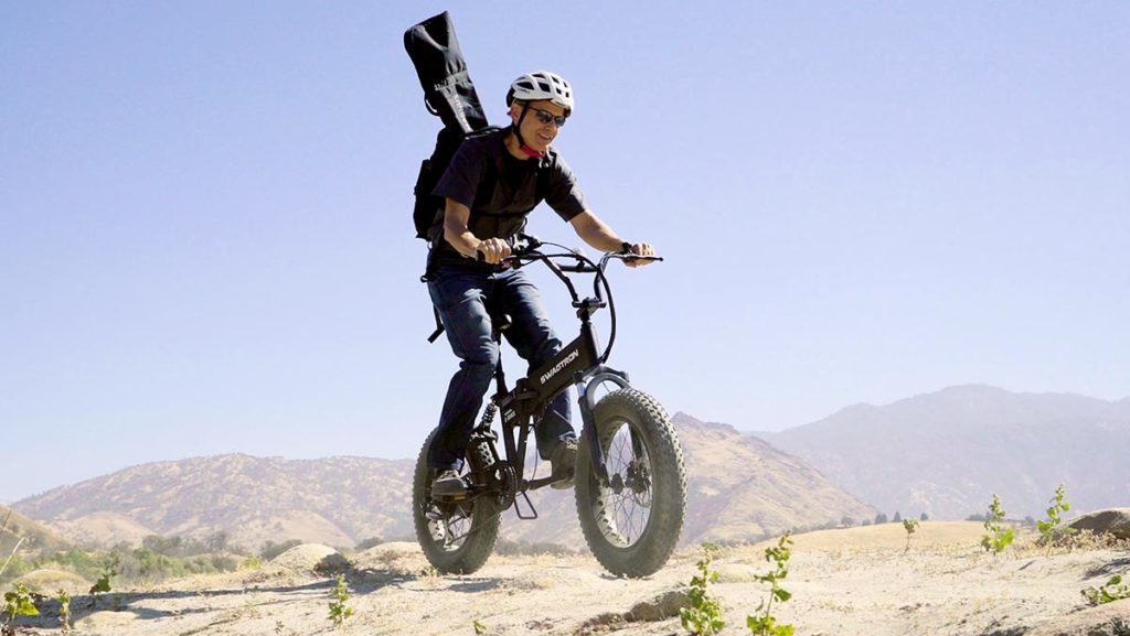 Older man riding on rough terrain on his EB8 Fat-Tire eBike.