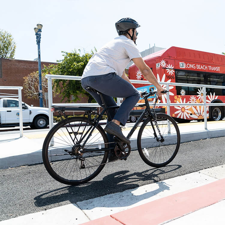 Man riding his EB12 Electric City Bike on his commute to work