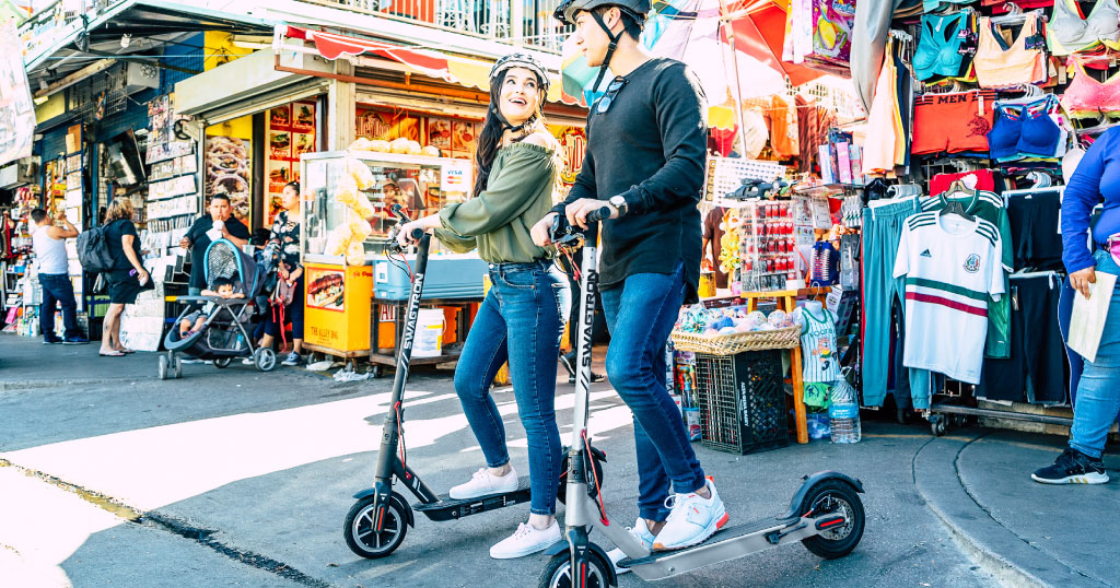 Young couple riding their Swagger 5 Elite Pro and Elite Pro Silver Edition eScooters with proper tire inflation.