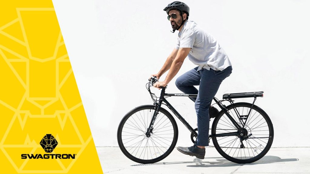 Man wearing a helmet riding a well-maintained EB12 electric road bike.