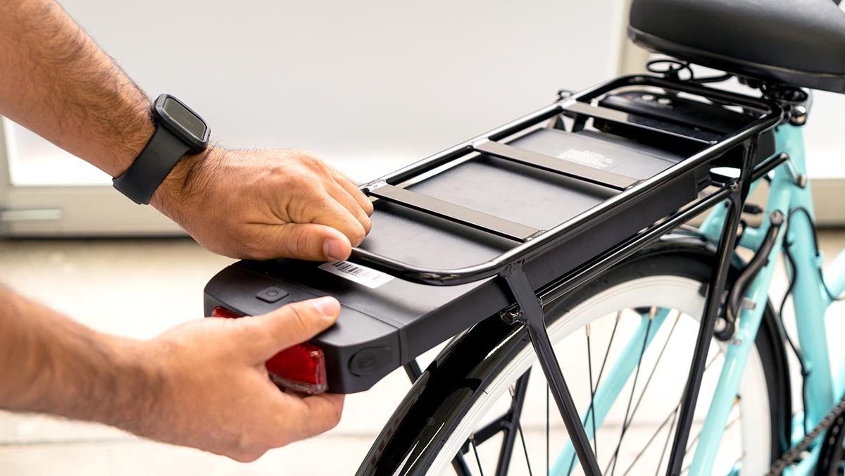 Close-up of a man removing the swappable EB9 battery.