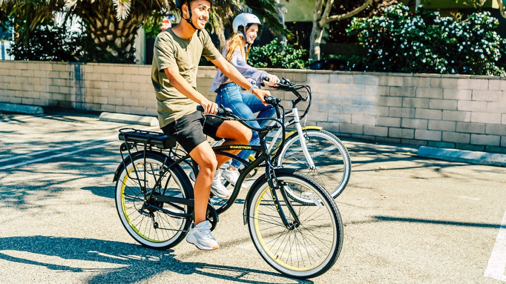 Couple wearing helmets, both riding their own EB11 eBike.