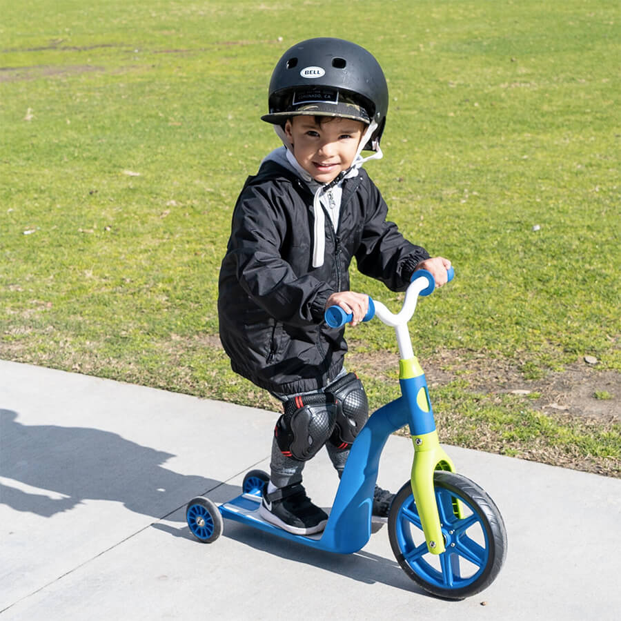 3 Year Old Kid riding a three wheel convertible toddler scooter