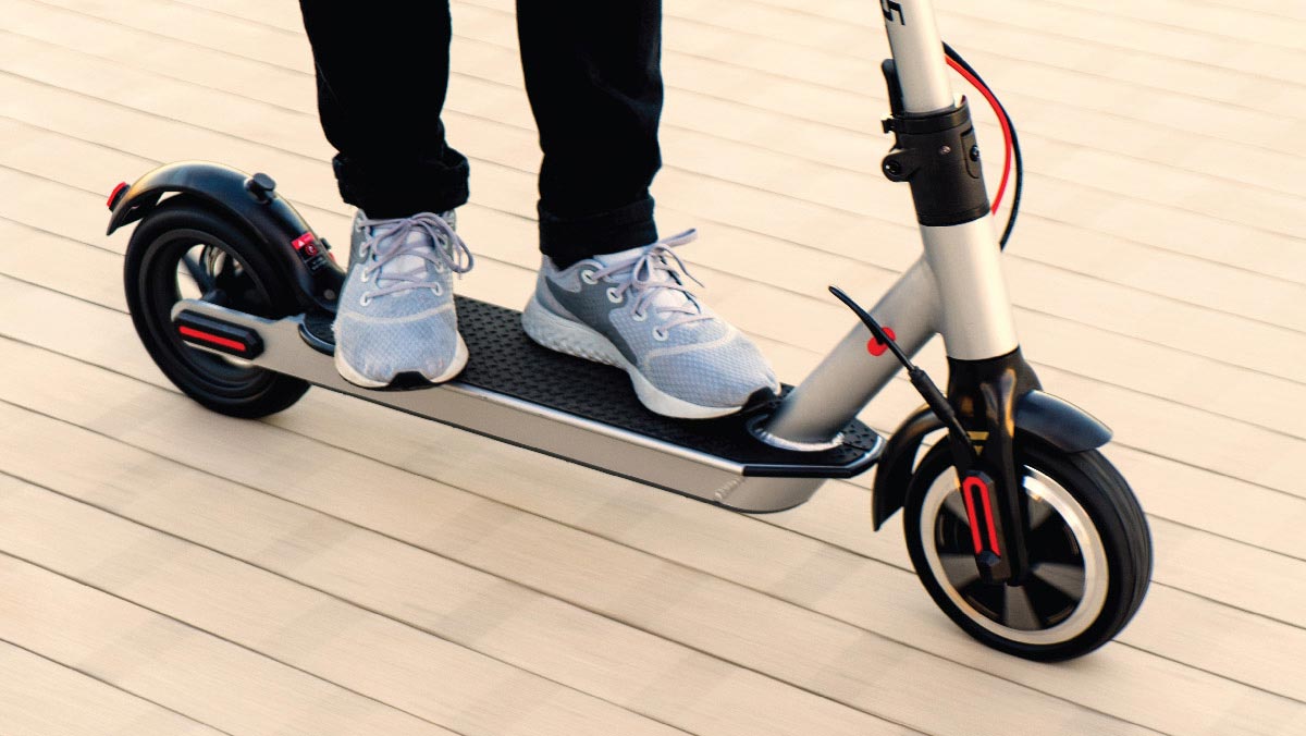 Person riding a SWAGTRON Swagger 5 Boost Electric Scooter