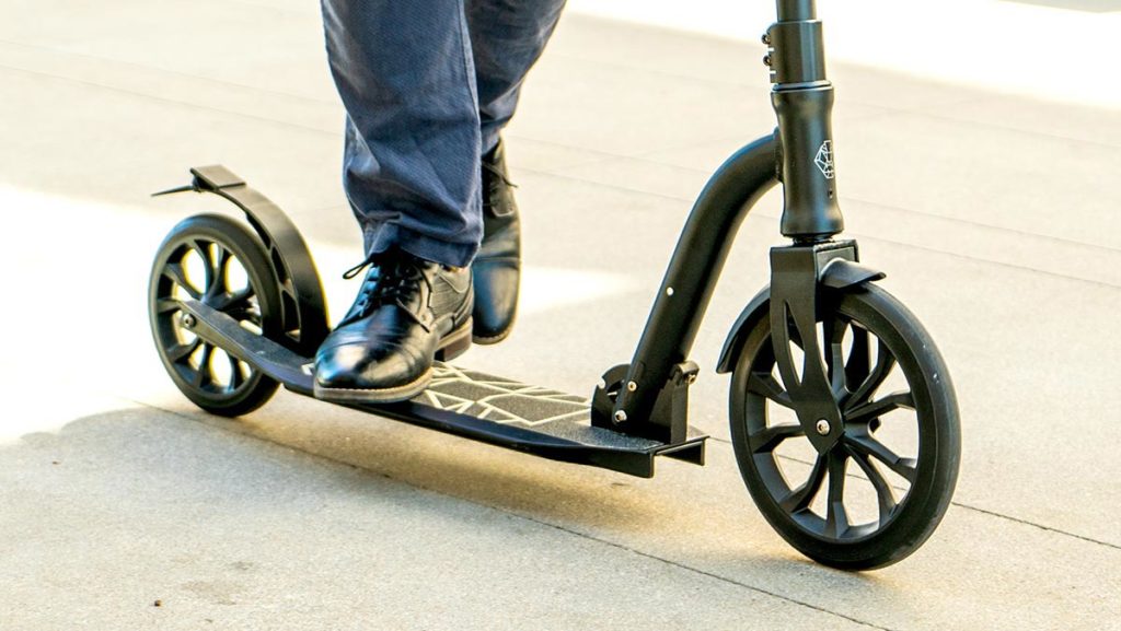 Man riding the K8 Kick Scooter.