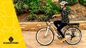 Older woman wearing a helmet while riding an EB9 electric bike.