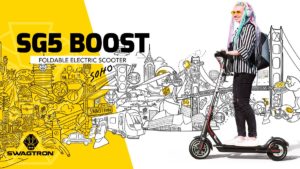 Young woman riding her Swagger 5 Boost in front of a mural illustration by Pretty Done