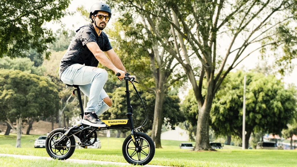 Man wearing helmet riding the EB7 Plus electric bike.