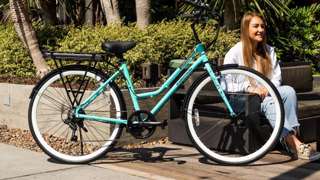 Woman sitting next to her EB9 electric bike.