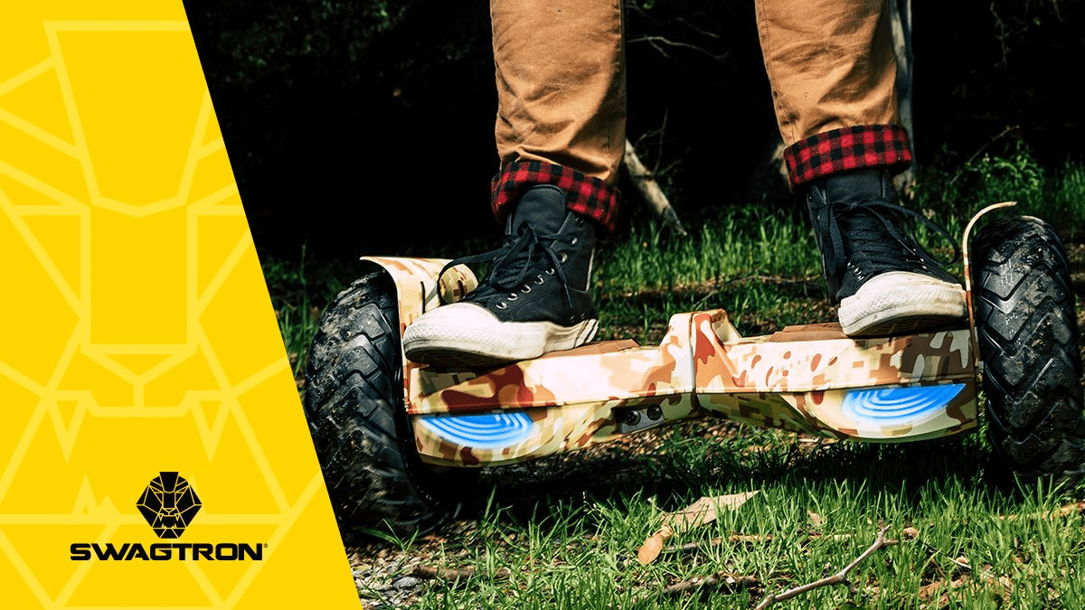 Closeup on guy standing on a T6 hoverboard on the grass.