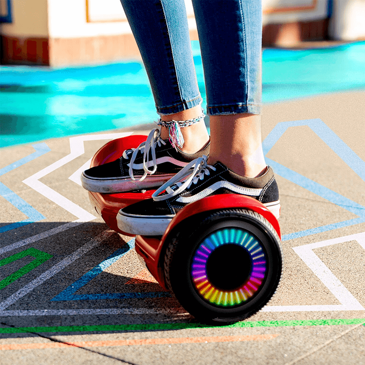 Girl riding her red Hoverboard Twist T881 with LED lights at a park