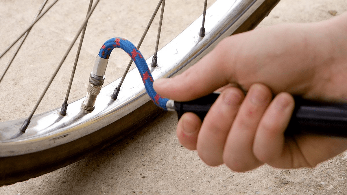 Closeup of someone using an pump extension with their air pump.